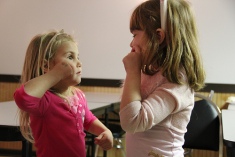 Two girls speak in sign language.