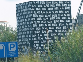 Big sign reads blah, blah, blah perhaps 100 times.