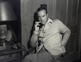 Black and white picture of a young Bob Hope on the telephone.